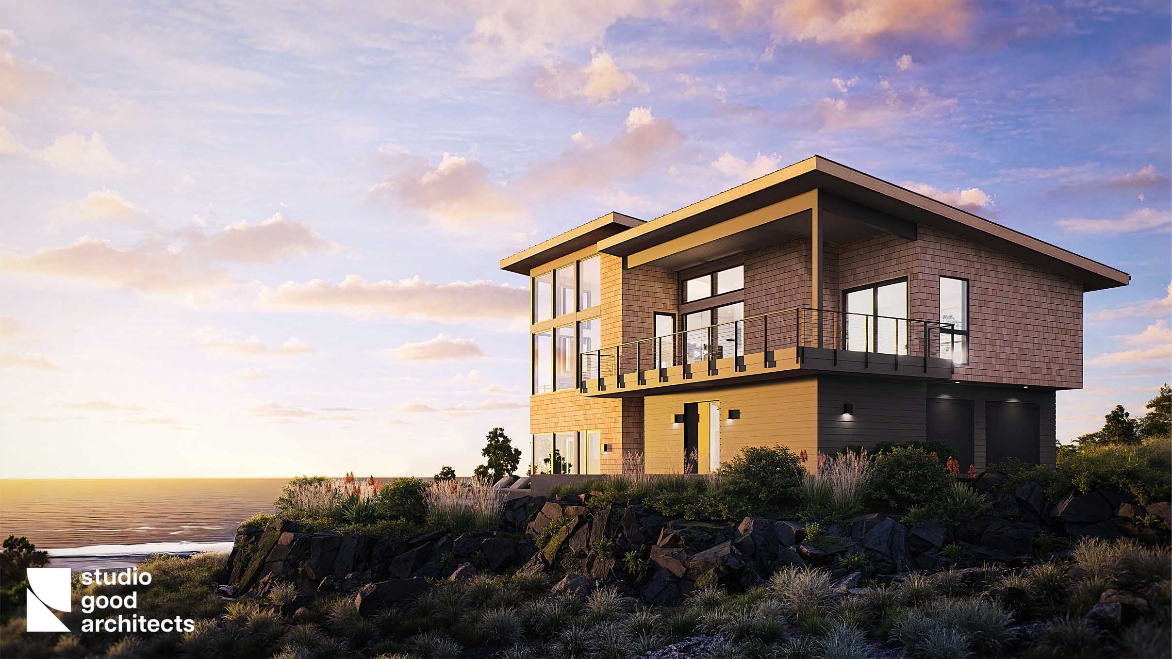 Modern coastal house design by Studio Good Architects, featuring large glass windows, a wooden exterior, and a balcony overlooking the ocean at sunset, surrounded by rocky terrain and lush vegetation.
